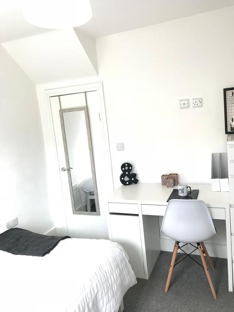 This inviting double bedroom features a cozy be...