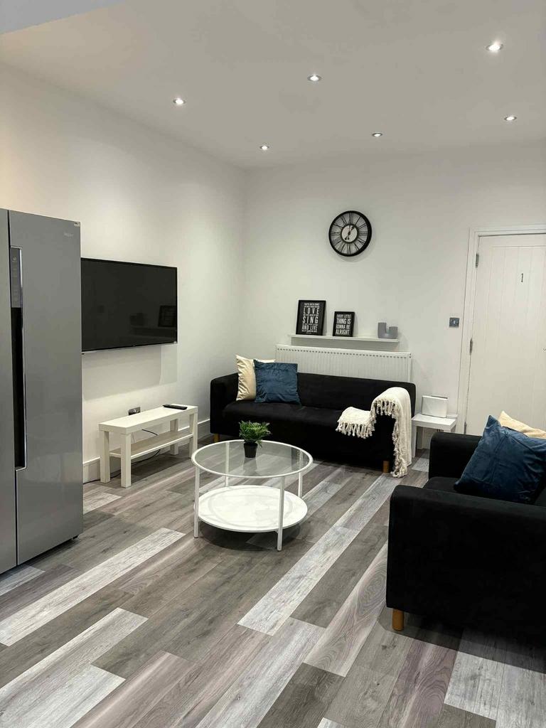 A modern and well-lit living room featuring sle...