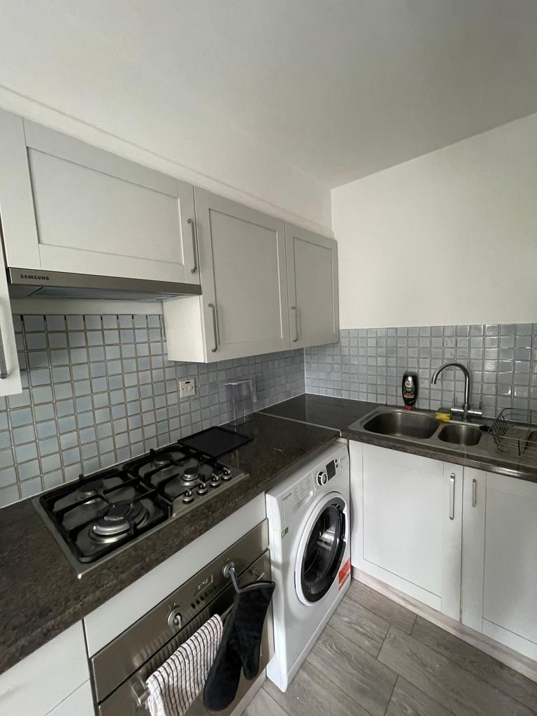 A modern and tidy kitchenette equipped with ess...