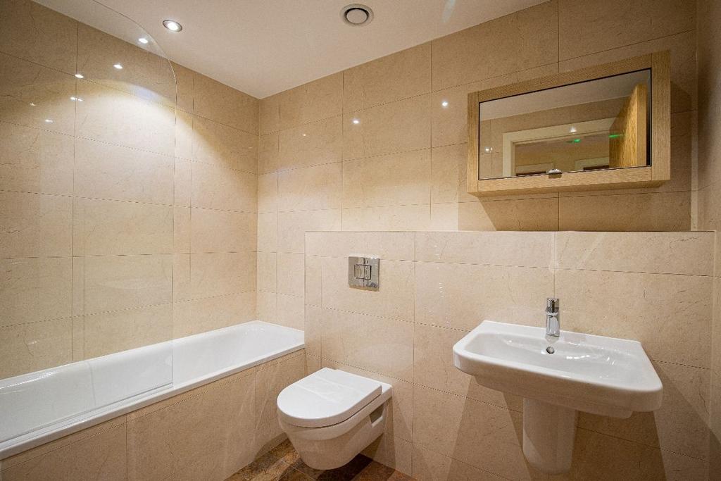 A modern and well-maintained bathroom suite fea...