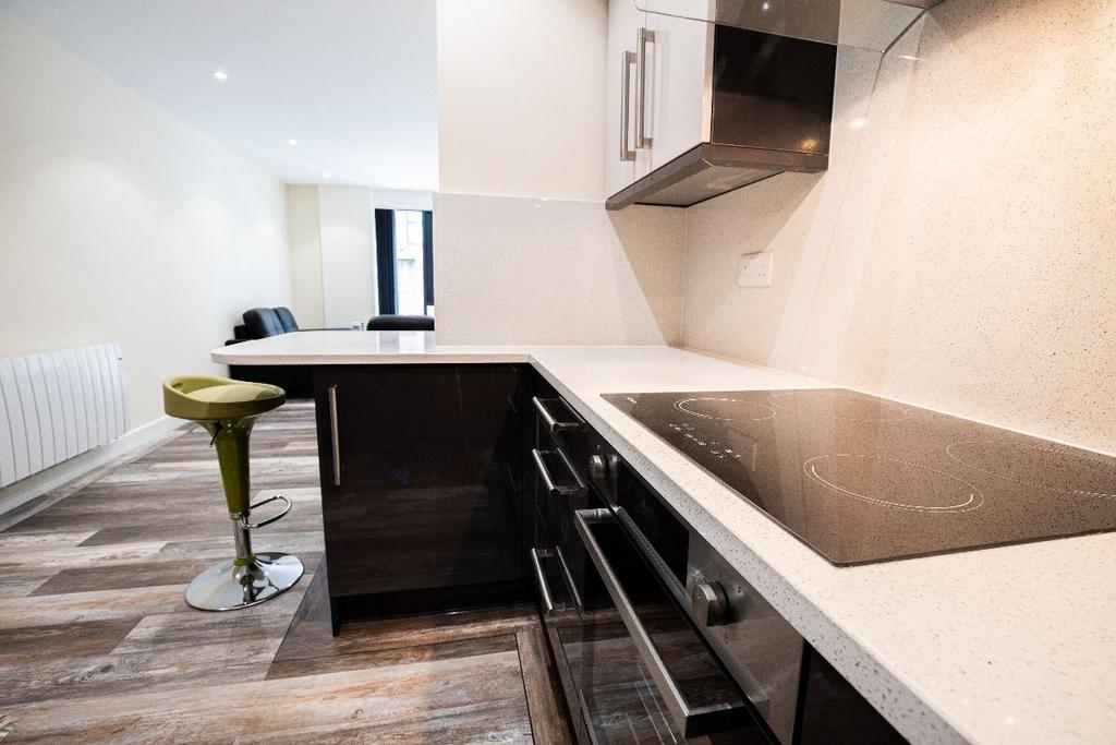 Modern kitchen space featuring sleek black cabi...