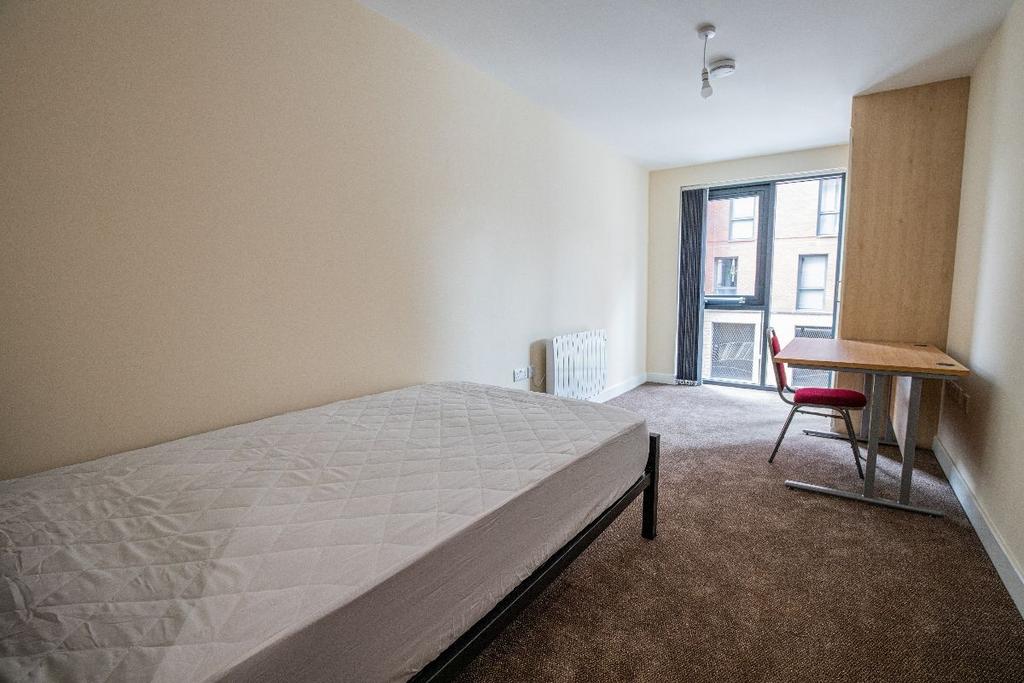 A tidy single bedroom featuring a comfortable b...
