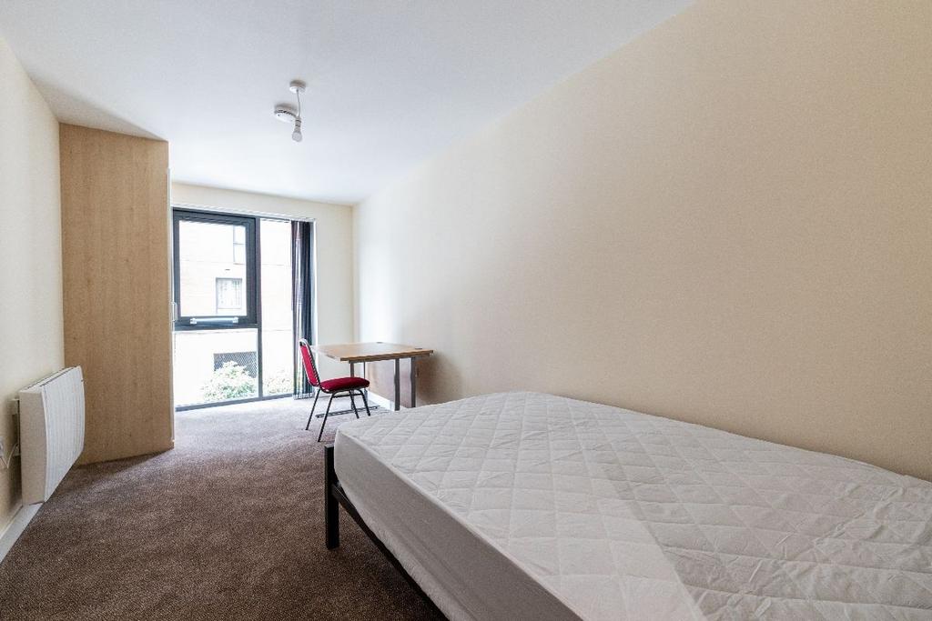A neat and simple single bedroom featuring a la...
