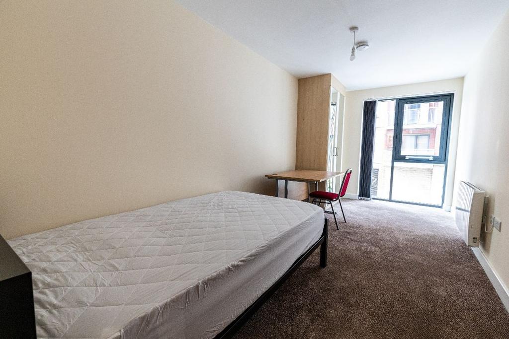 A bright and tidy double bedroom featuring a la...