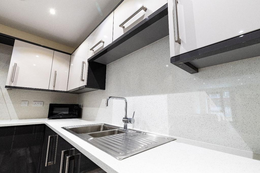 Modern kitchen featuring sleek black and white ...