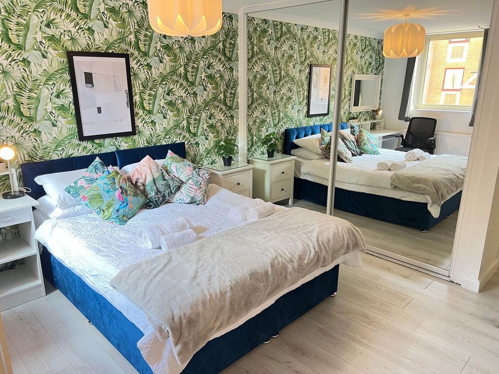 A stylish and bright master bedroom featuring a...