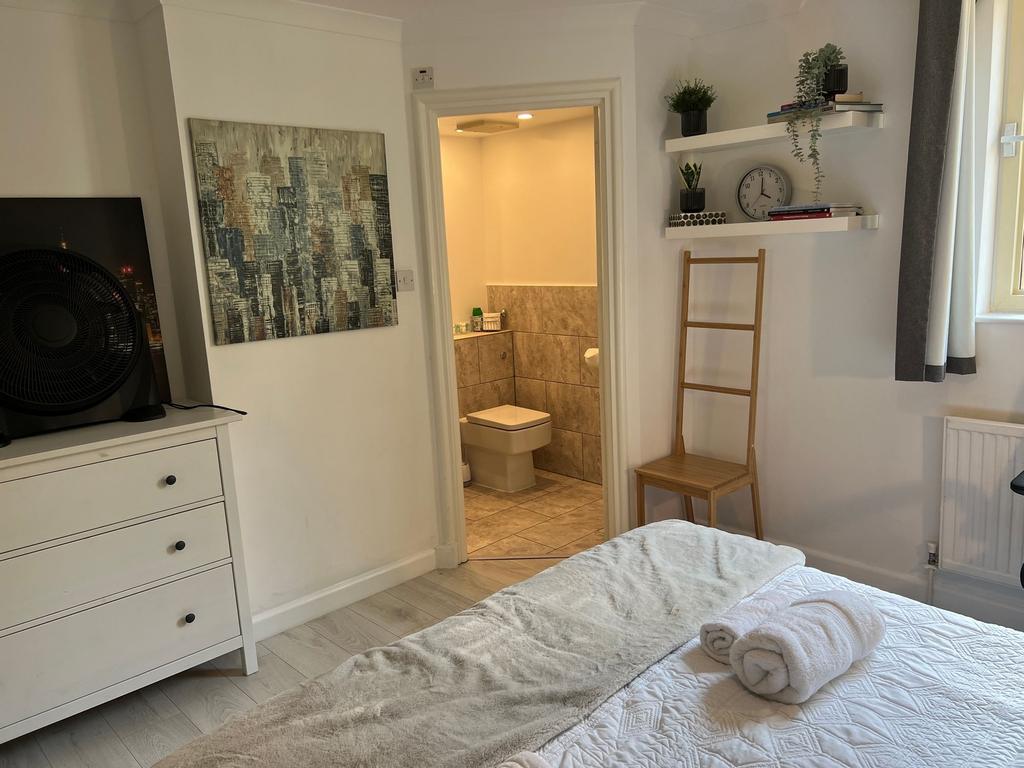 A bright and inviting master bedroom featuring ...