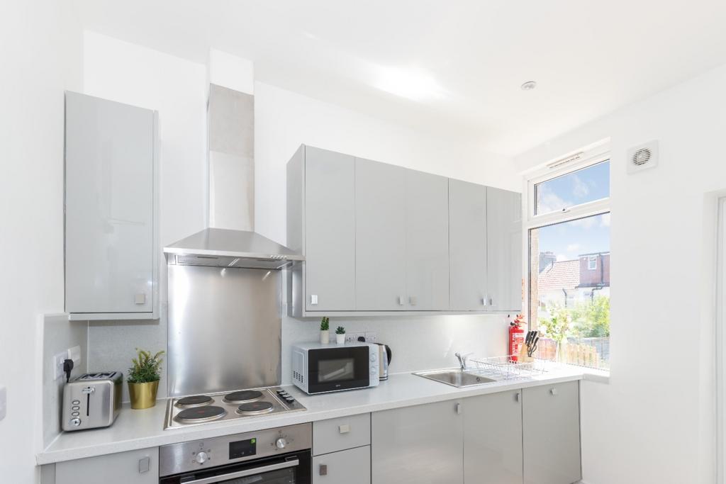 This modern kitchen features sleek cabinetry an...