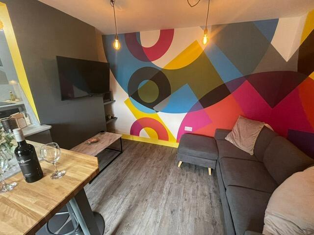 A modern living room featuring a vibrant, color...