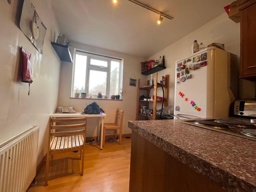 Bright kitchen space featuring wooden flooring,...