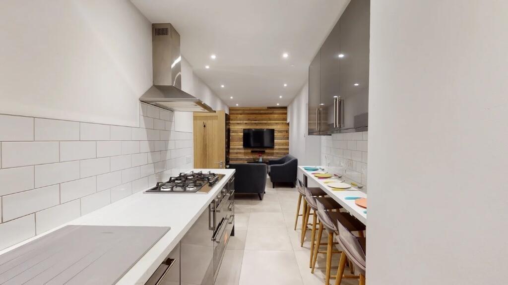 Bright and modern kitchen featuring sleek white...
