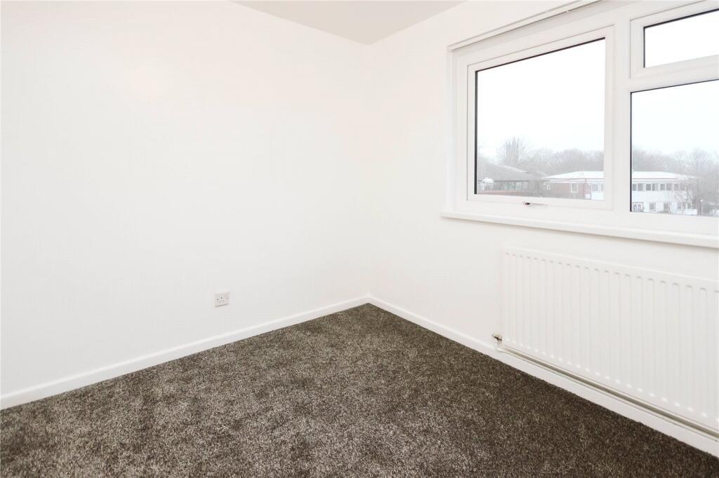 A bright and clean single bedroom featuring a l...