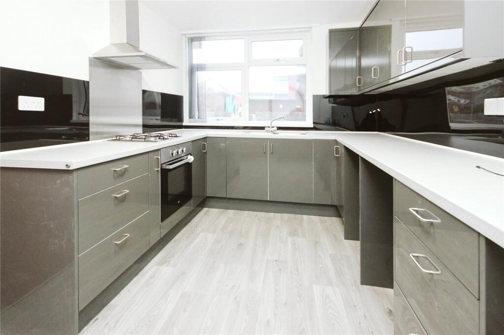 Bright and modern kitchen featuring sleek cabin...