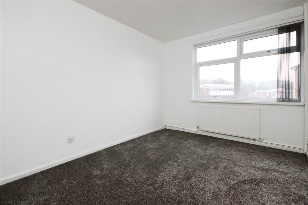 A clean and bright double bedroom featuring a l...
