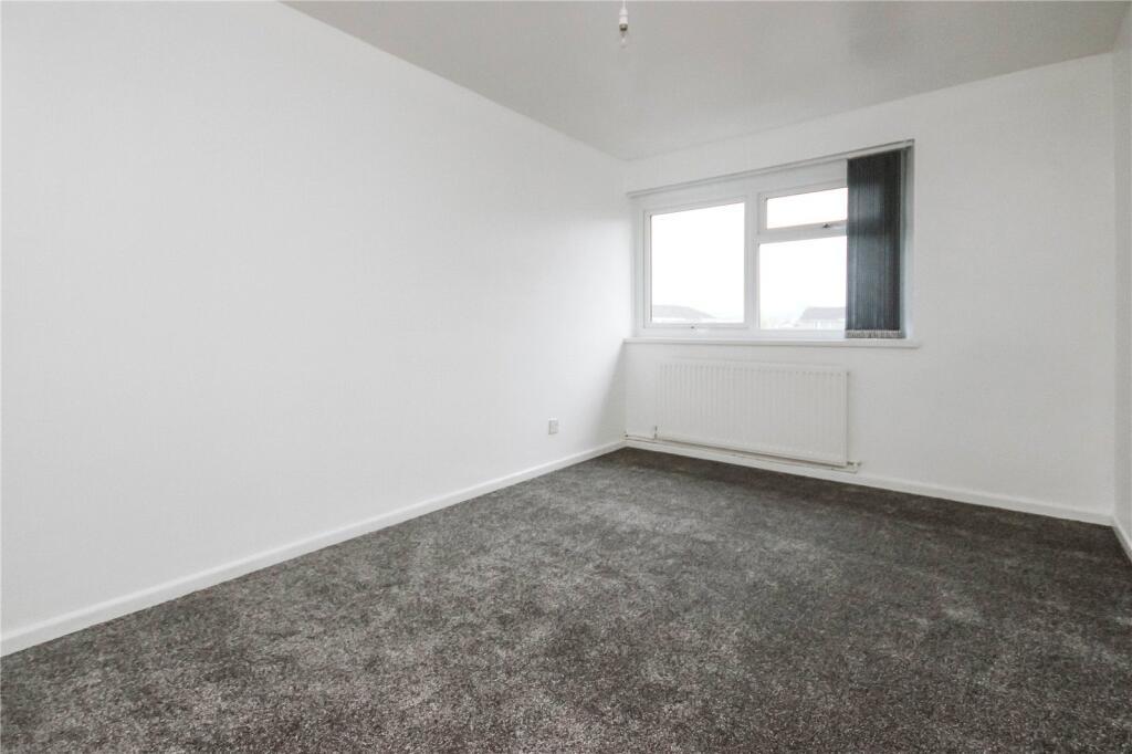 A clean and bright double bedroom featuring a l...
