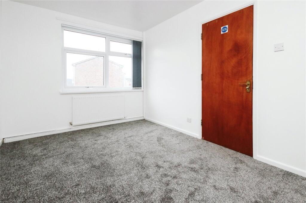 A clean and bright single bedroom featuring a l...