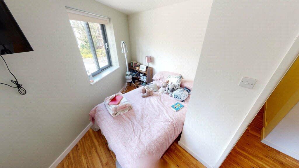 A bright and cozy double bedroom featuring a co...
