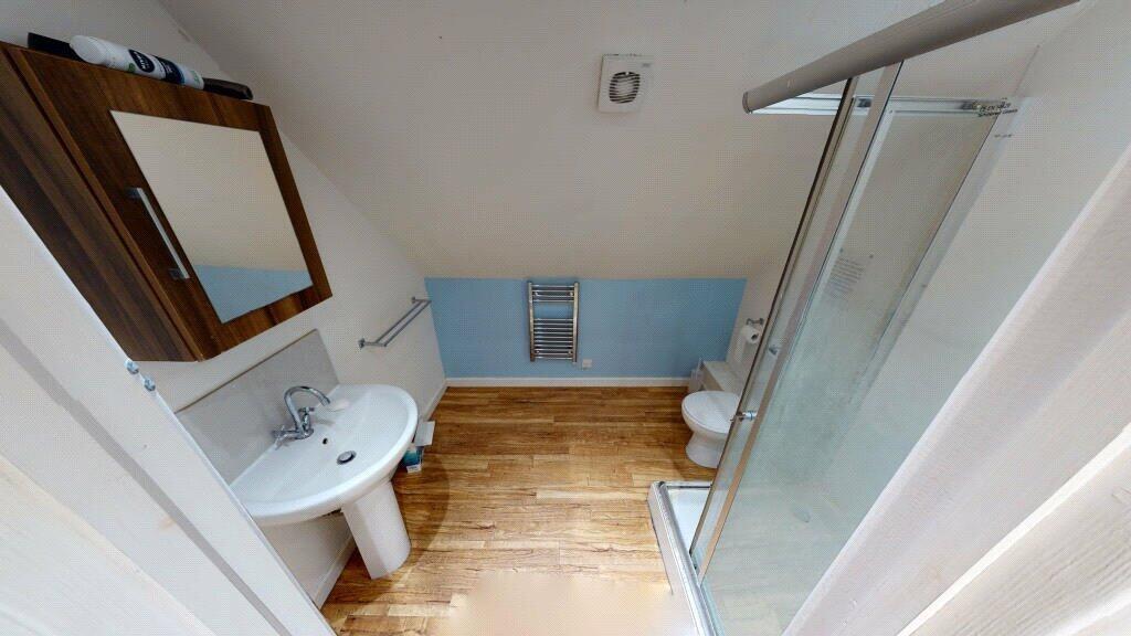 A clean and modern bathroom featuring a corner ...
