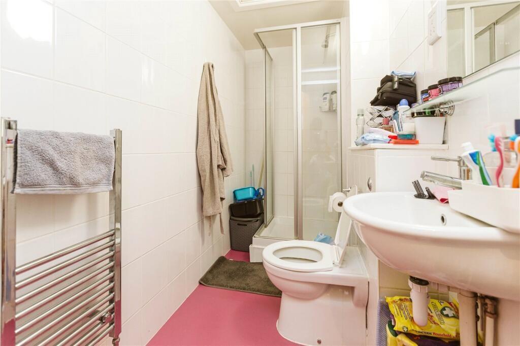 Bright and tidy bathroom featuring modern white...