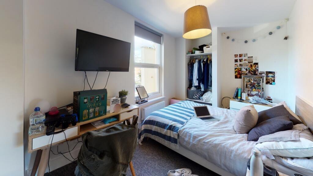 This inviting double bedroom features a cozy la...