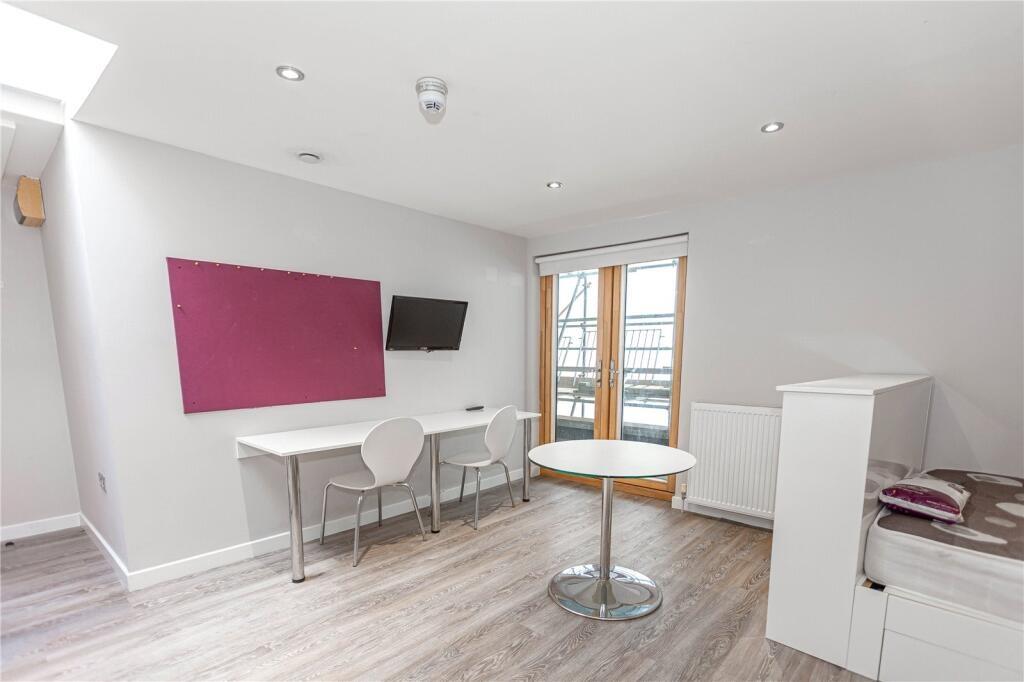 Bright and modern communal workspace featuring ...