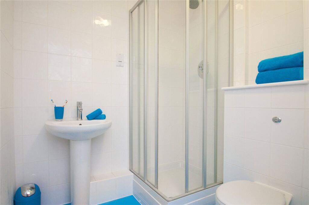 Bright and clean bathroom featuring a modern sh...