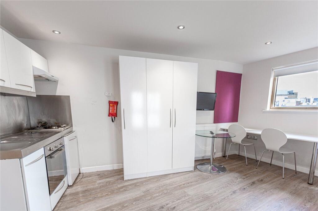 Bright and modern kitchen featuring sleek white...