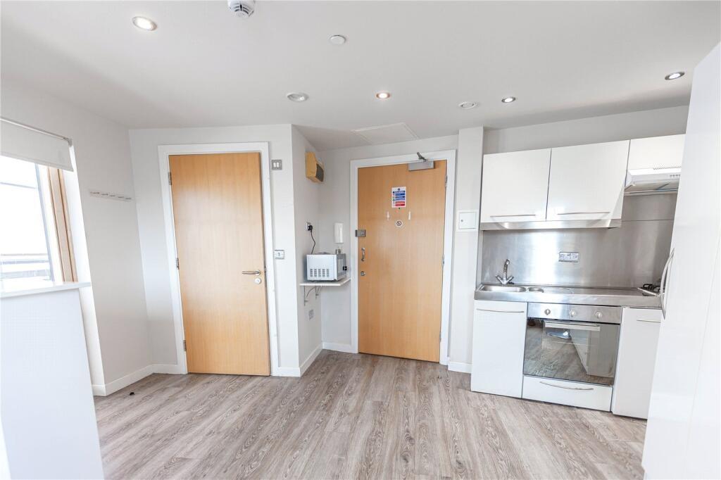 Bright and modern kitchen area featuring light ...