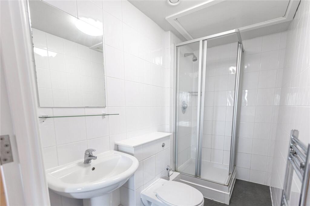 Bright and modern bathroom featuring a clean wh...