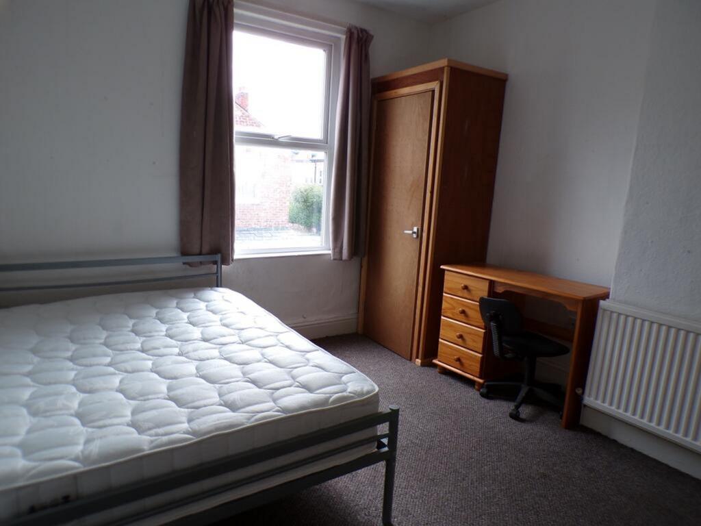 A cozy double bedroom featuring ample natural l...