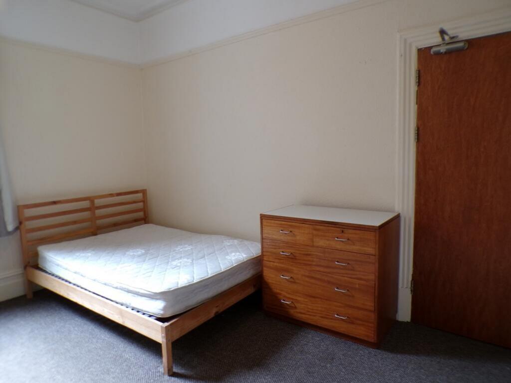 Bright and spacious double bedroom featuring a ...
