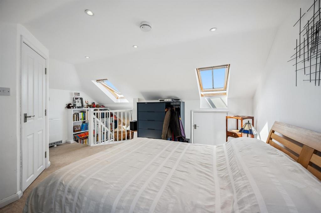 Bedroom Three towards stairs and fitted bookcase.j