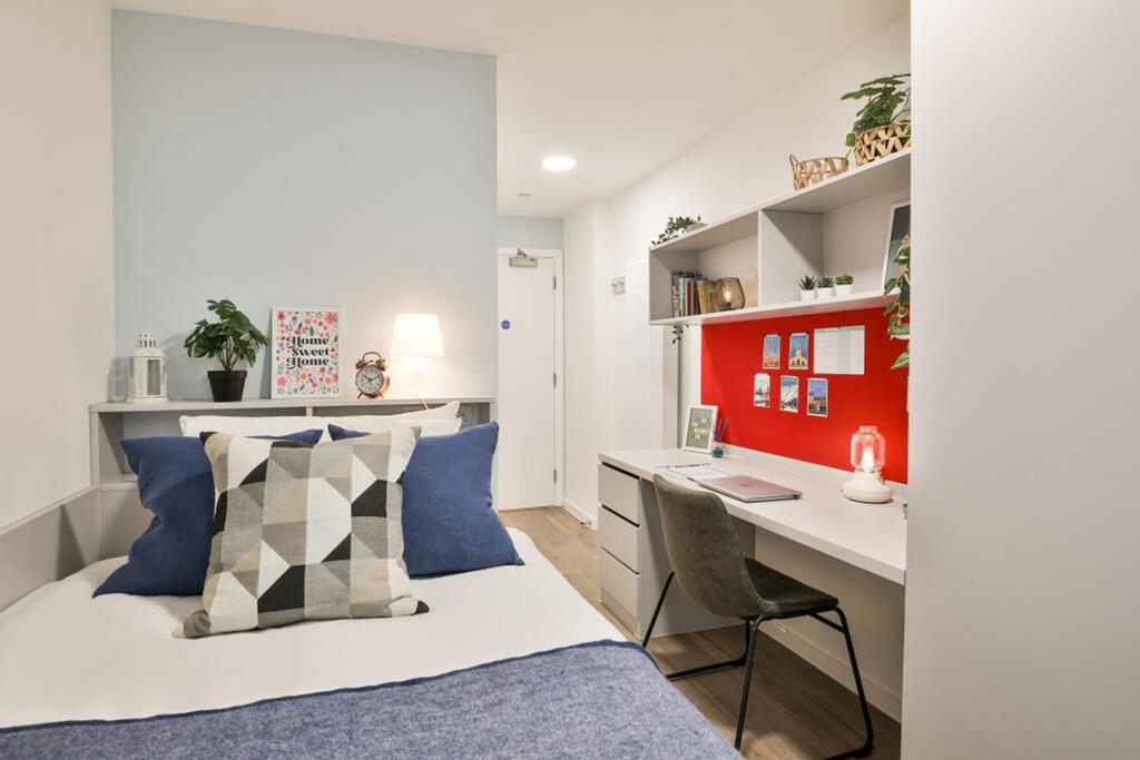 This stylish double bedroom features a cozy lay...