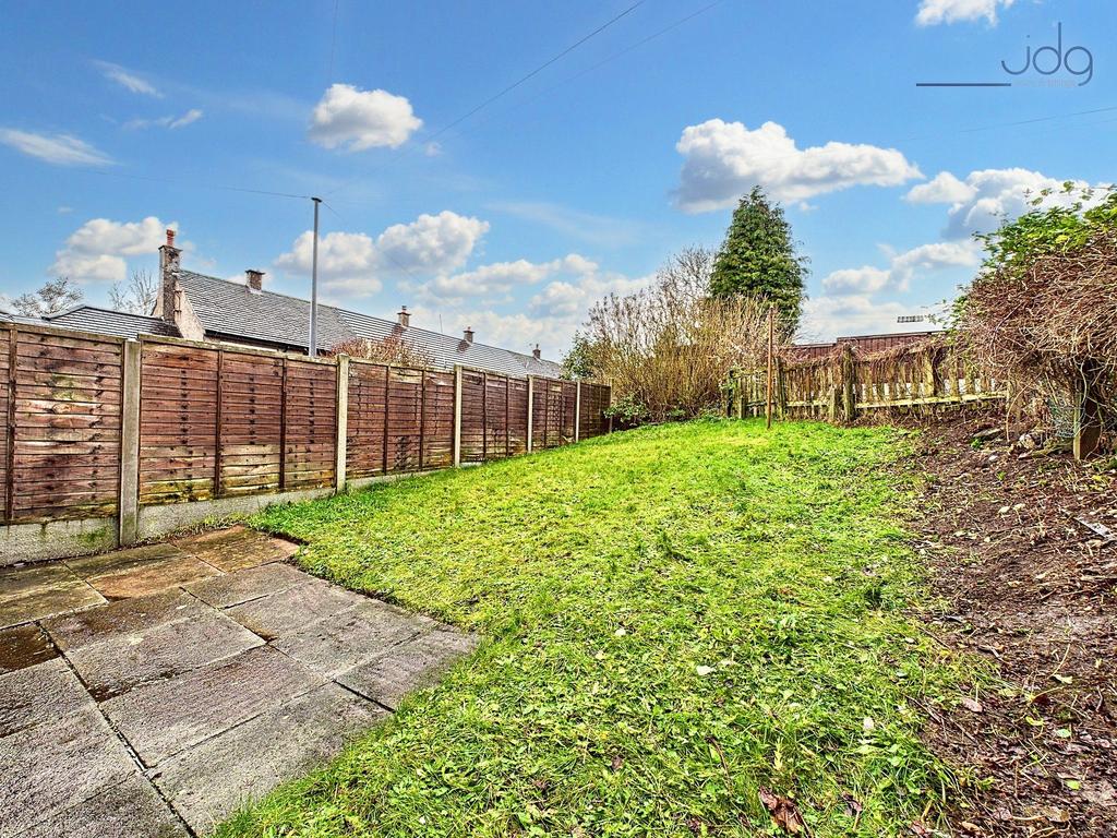 Spacious Garden with a mixture of flags and lawn