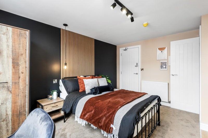 A stylish double bedroom featuring a cozy doubl...