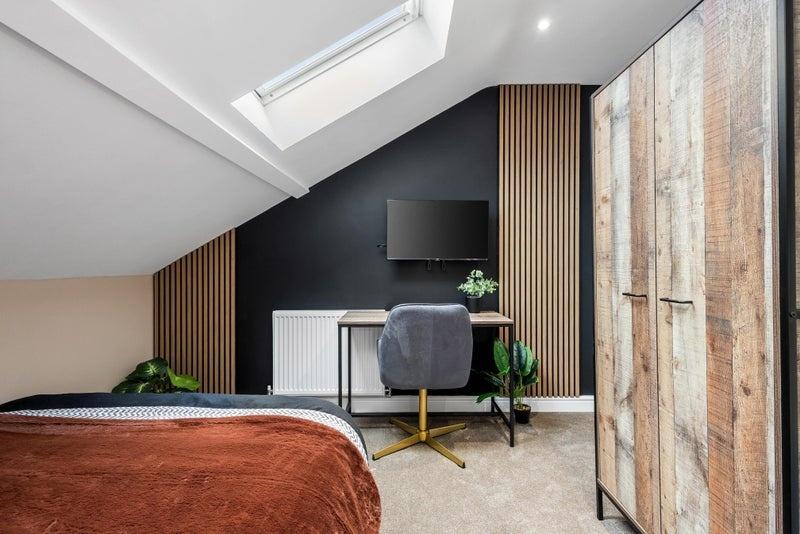 A stylish double bedroom featuring a modern slo...