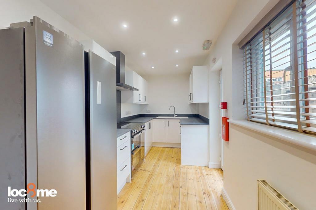 A modern and well-lit kitchenette with sleek ap...