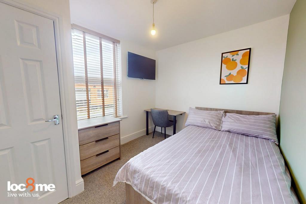 A bright and inviting double bedroom featuring ...