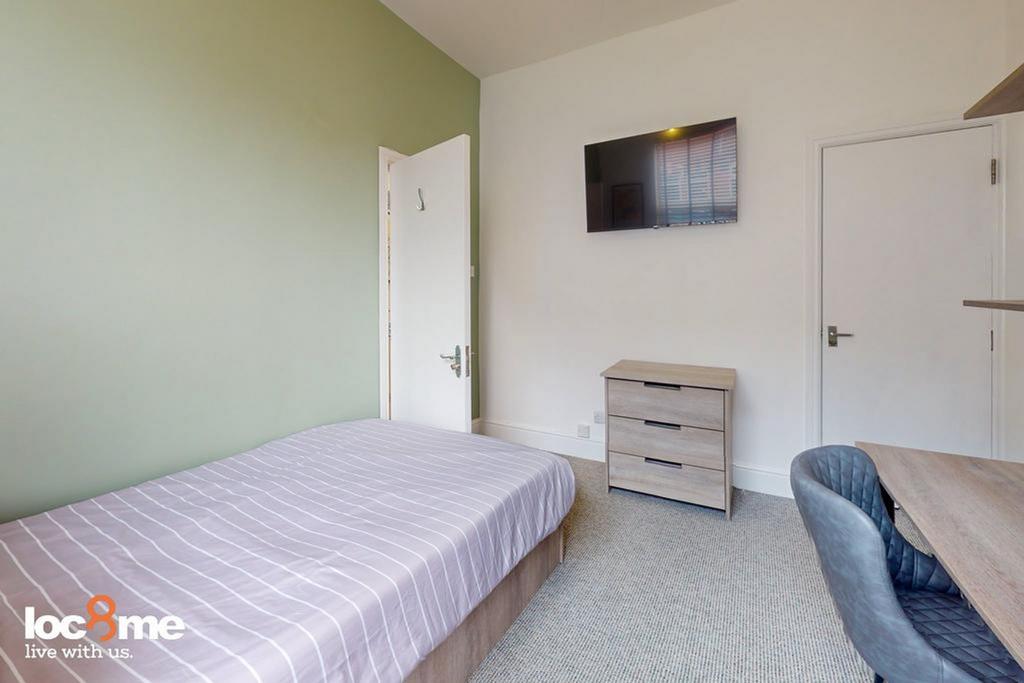 A bright and inviting double bedroom featuring ...