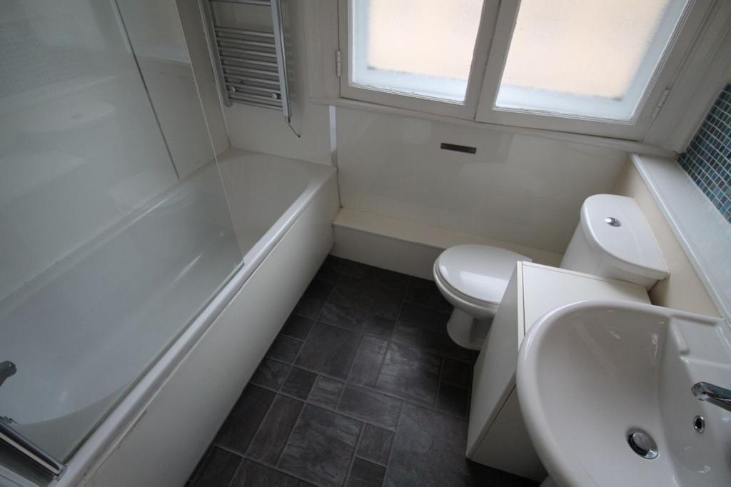 A clean and modern bathroom featuring a sleek d...