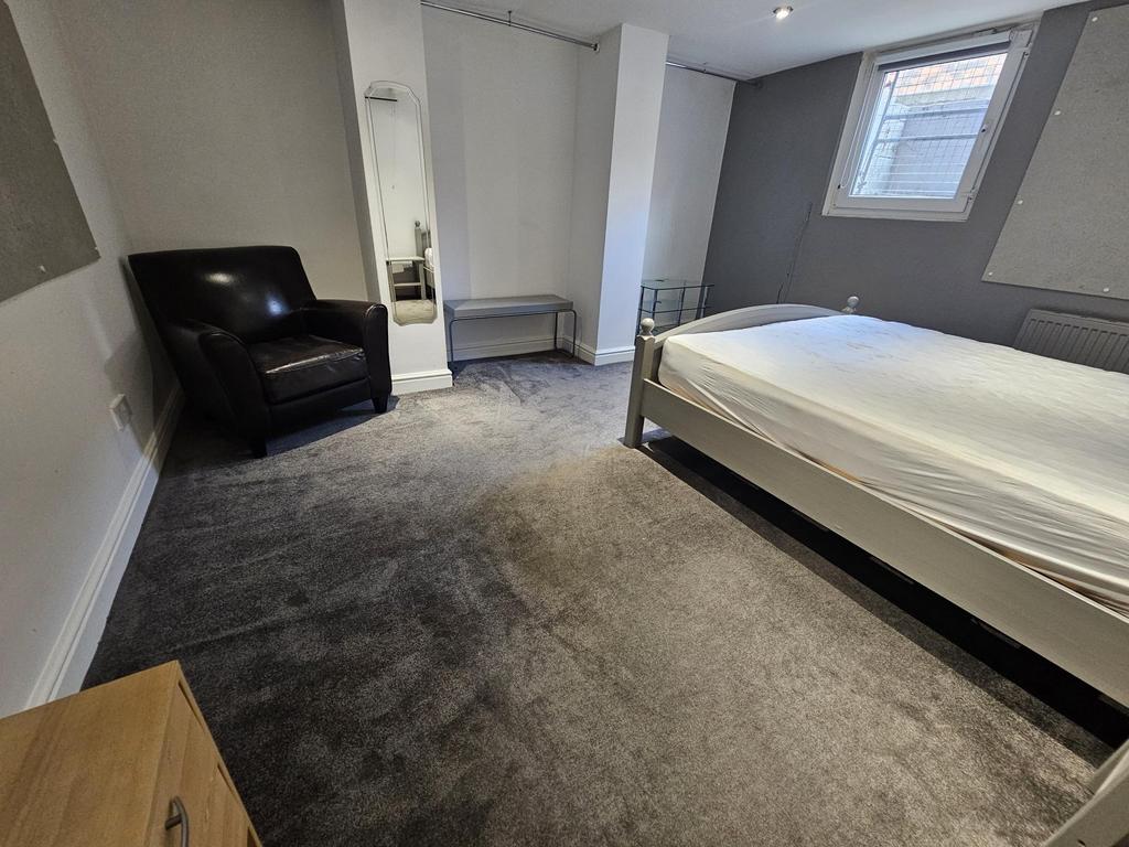A spacious master bedroom with ample natural li...