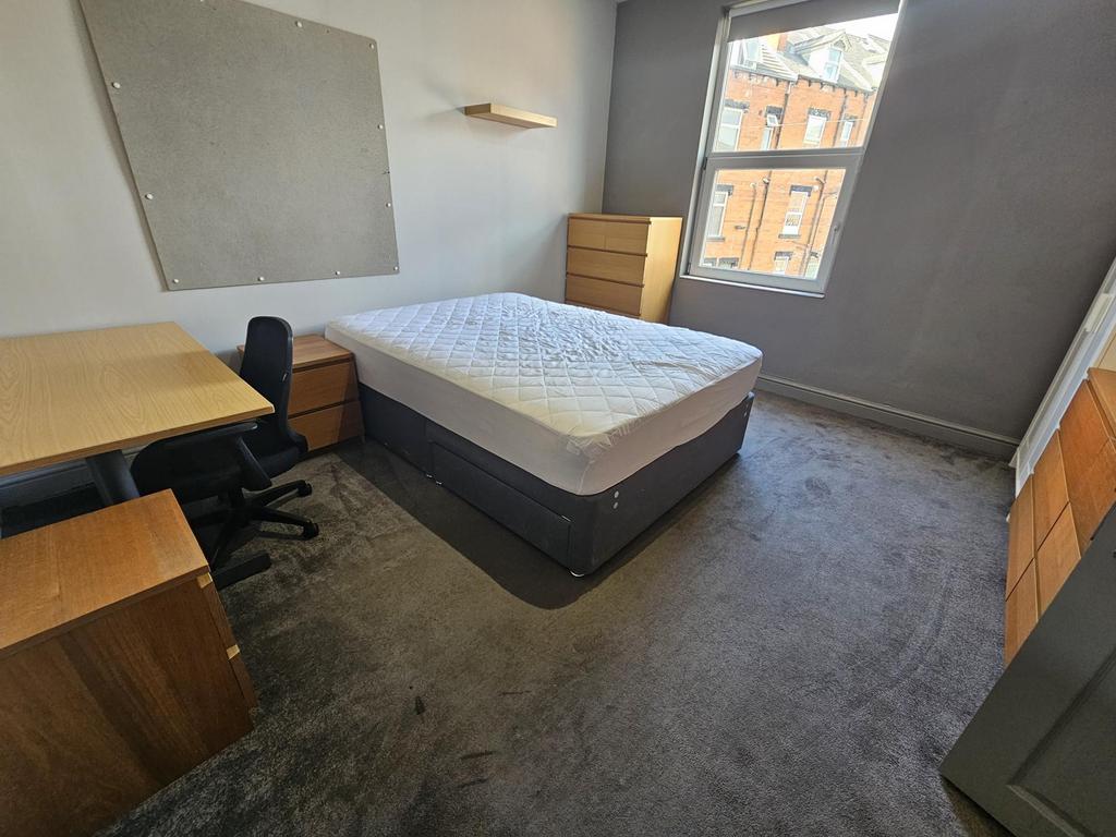 A spacious and well-lit double bedroom featurin...