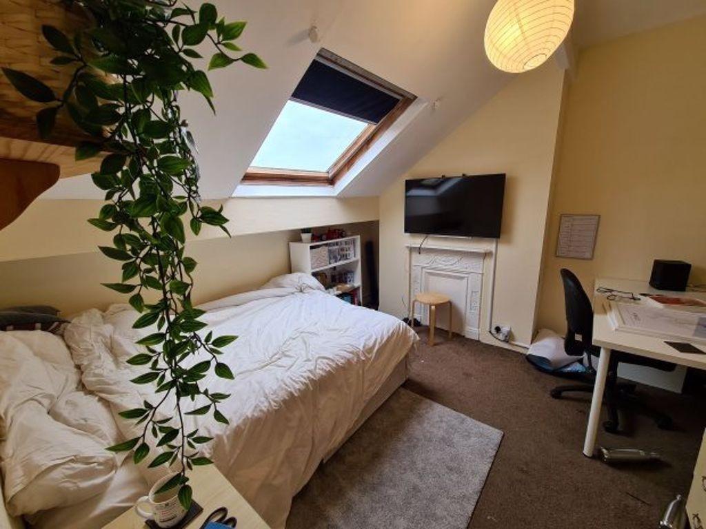 Bright and cozy master bedroom with a comfortab...