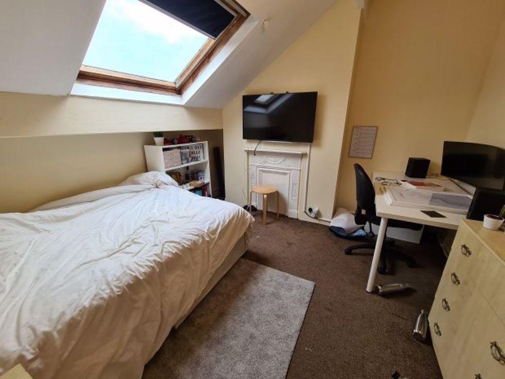 Cozy single bedroom featuring a comfortable bed...