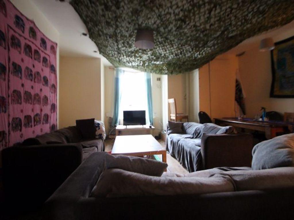 A cozy living room featuring multiple seating o...