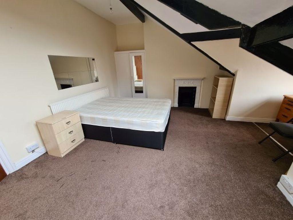 Spacious master bedroom featuring a large bed, ...