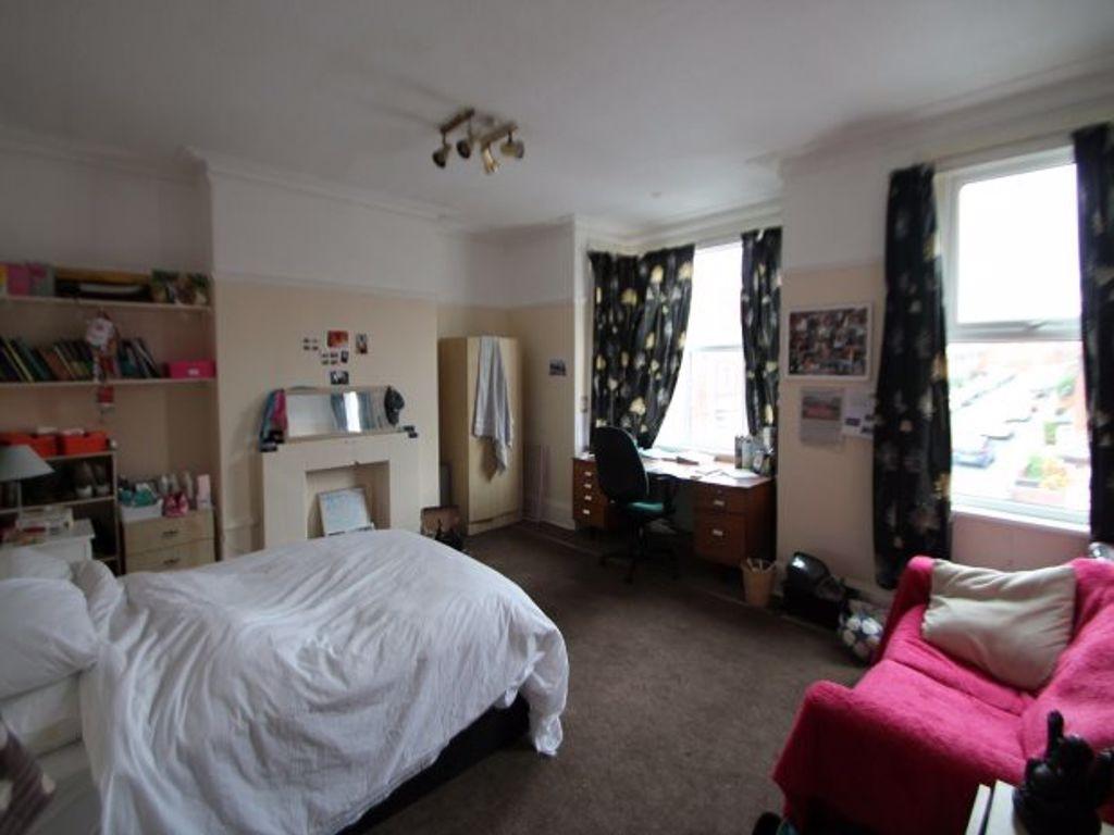 Bright and spacious bedroom featuring a comfort...