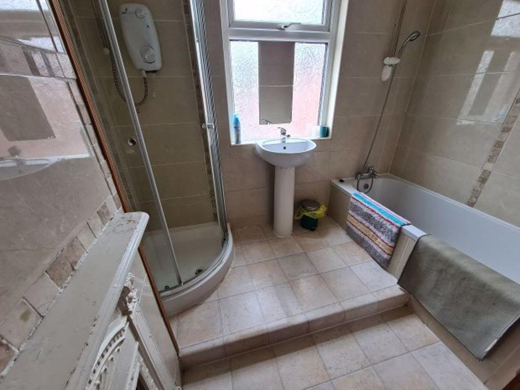 Bright and well-maintained bathroom suite featu...
