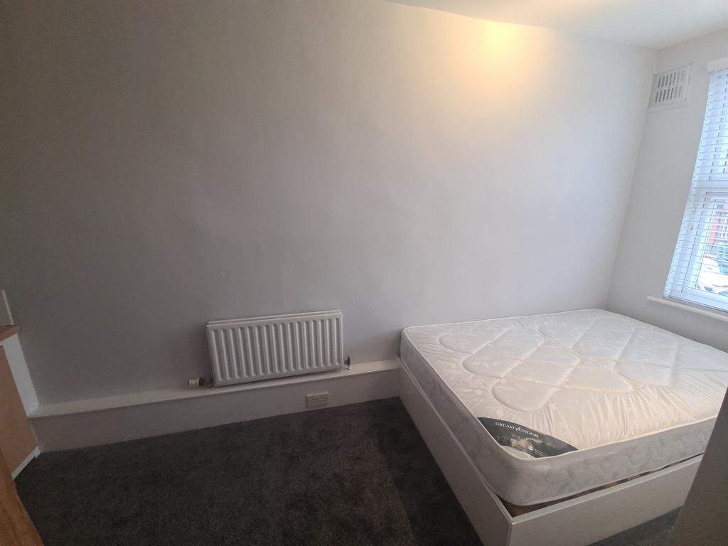 A bright and tidy double bedroom featuring a co...