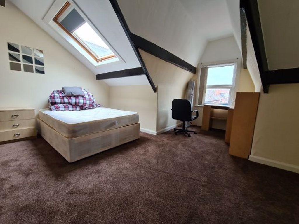 A cozy single bedroom featuring a comfortable b...